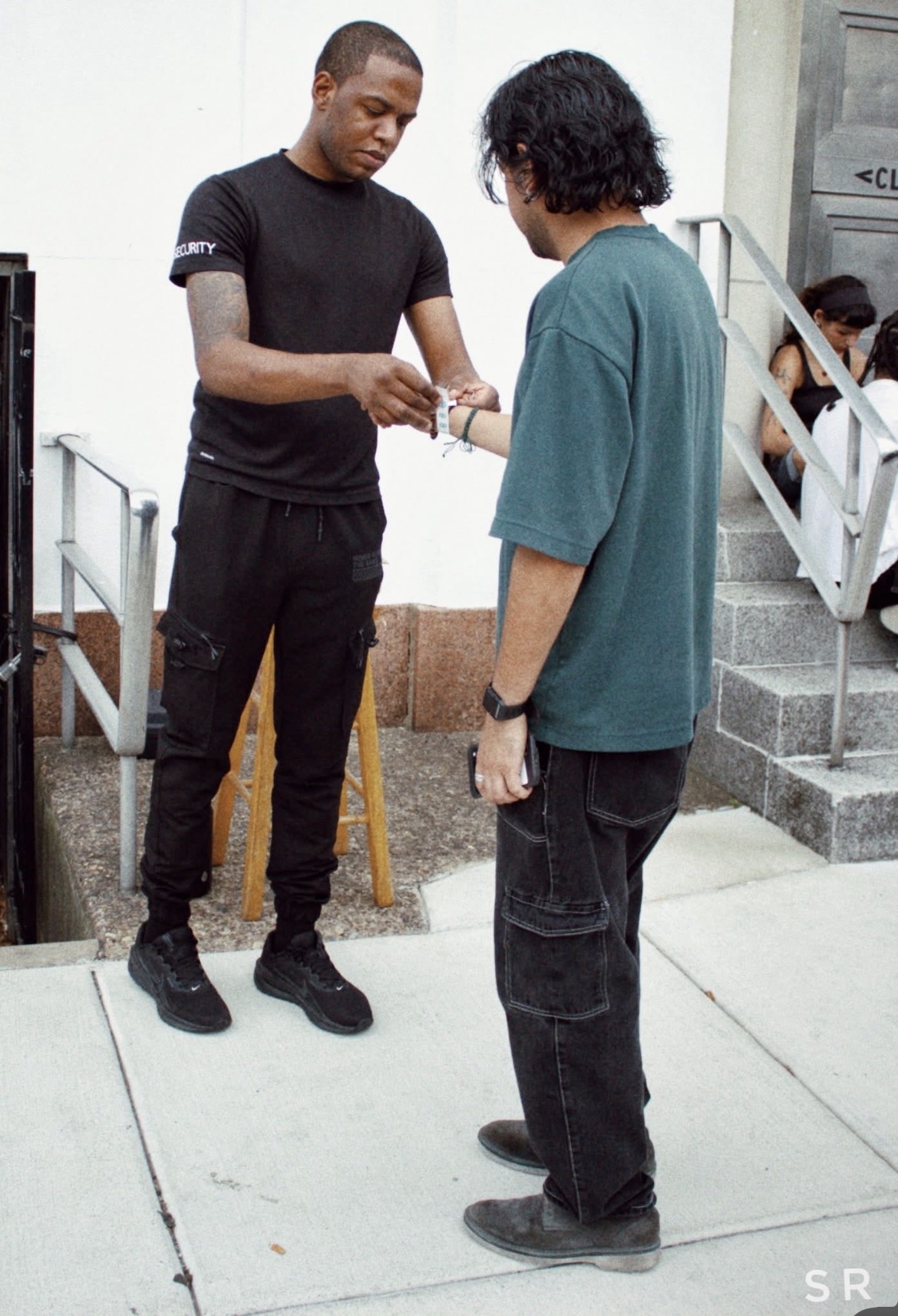 ShieldBox team member applying a wristband during event entry operations